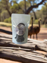 Load image into Gallery viewer, GOURMET DEHYDRATED EMU & BUSH PLUM PATTIES 100g packaging in a natural outdoor setting.