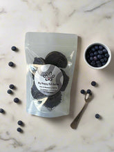 Load image into Gallery viewer, GOURMET DEHYDRATED EMU & BLUEBERRY PATTIES 100g in a clear package with blueberries on a marble surface.
