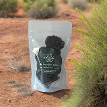 Load image into Gallery viewer, GOURMET DEHYDRATED EMU & ANISEED MYRTLE PATTIES 100g in a resealable pouch, displayed outdoors.