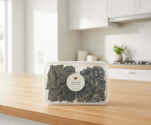 Load image into Gallery viewer, VARIETY PACK - DEHYDRATED DOG TREATS in a clear container on a kitchen countertop, offering diverse flavours for dogs.
