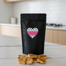 Load image into Gallery viewer, Black bag with a heart design and dog treats on a kitchen bench