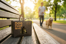 Load image into Gallery viewer, Dog poop bag packaging with a cartoon dog on top, displayed on a clear surface.