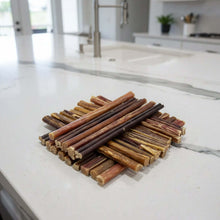Load image into Gallery viewer, PREMIUM AUSTRALIAN BEEF BULLY STICKS arranged on a sleek kitchen countertop, showcasing their quality and appeal.