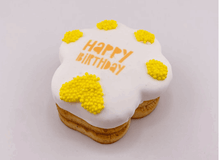 Load image into Gallery viewer, BIRTHDAY PAW PRINT CAKE, a yellow decorative cake with white icing and text "HAPPY BIRTHDAY" for pets.