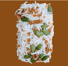 Load image into Gallery viewer, Doggy Nutribar covered in coconut flakes and topped with pepitas and dried fruits.