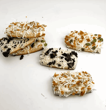 Load image into Gallery viewer, Doggy Nutribar baked treats featuring coconut, seeds, and unique toppings, promoting a tasty dog diet variety.