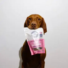 Load image into Gallery viewer, Dog holding a bag of BABY G0T MACK - Mackerel Bites, showcasing delicious pet treats.