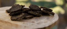 Load image into Gallery viewer, GOURMET DEHYDRATED EMU & ANISEED MYRTLE PATTIES 100g displayed on a wooden surface.