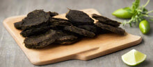Load image into Gallery viewer, GOURMET DEHYDRATED EMU & DESERT MIX PATTIES 100g displayed on a wooden cutting board with lime and green chili.