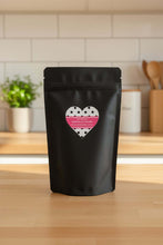 Load image into Gallery viewer, PUMPKIN OAT DOG COOKIES packaged in a black pouch with a heart label on a kitchen counter.