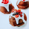 Delicious DOGGY BERRY & LIVER CHRISTMAS PUDDING decorated with berries and white icing for festive pet treats.