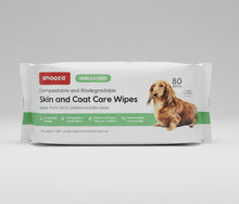 Load image into Gallery viewer, A package of Snooza Skin and Coat Care Wipes for dogs, featuring a white background with green and red text, a brown dachshund illustration, and a 'UNBLEACHED' label.
