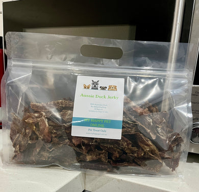 Bag of Aussie Duck Jerky pet treat with a label on a white surface.